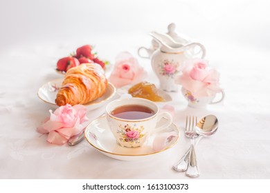 Breakfast With Tea, Croissants And Fresh Strawberries Served With Fine China Porcelain Set With Roses