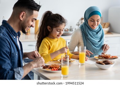 Breakfast Time. Middle Eastern Family Of Three Enjoying Tasty Food In Kitchen, Happy Arabic Parents And Their Little Daughter Sitting At Table, Having Delicious Meal In The Morning, Closeup