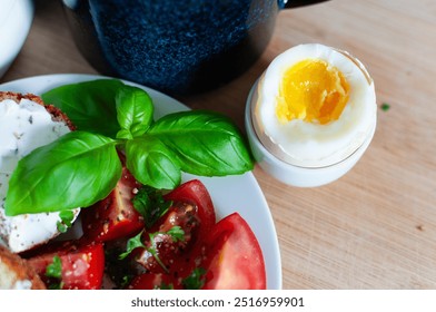 Breakfast tomato salad, muffins with cream cheese, coffee and hardboiled egg - Powered by Shutterstock