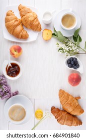 Breakfast - two cups of coffee, croissants, jam, honey and fruits on white table.  Top view. Copy space. - Shutterstock ID 684901840