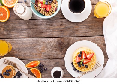 Breakfast waffles with fresh berries stacked on a plate - Shutterstock ID 294085964