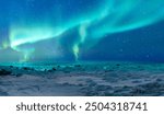 Breaking blue ice over frozen Norwegian Sea - Northern lights or Aurora borealis in the sky over Tromso, Norway