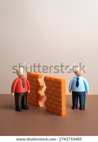 Breaking down the wall of misunderstanding between the parties and a chance to resolve the conflict. Reconciliation and open dialogue. Conflict resolution and partnership recovery concept.