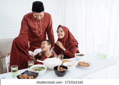 Breaking Fast Together. Asian Family Enjoy And Joking When Breaking Fast Together At Home