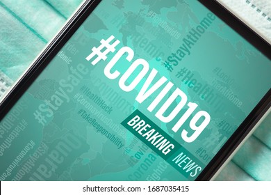 Breaking News, Coronavirus Or Covid-19 Outbreak Background Concept. Mockup Mobile Phone Covid19 News On Light Blue Facial Masks. Flat Lay Top View.