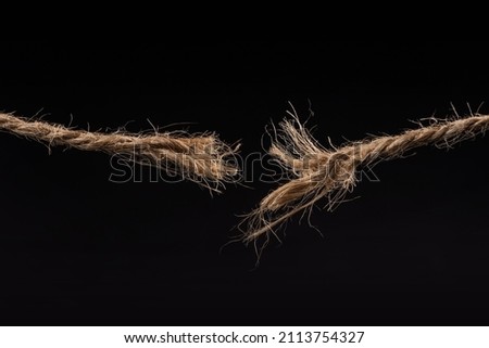 Breaking rope isolated on black background.
