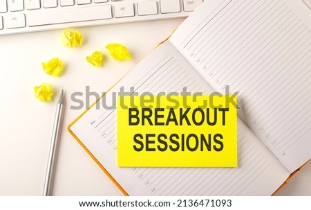 BREAKOUT SESSION text on sticker on diary with keyboard and pencil