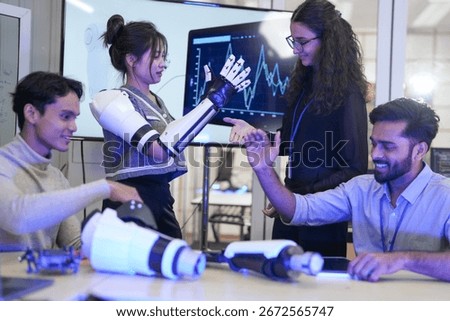 A breakthrough in human augmentation. A female engineer tests the haptic feedback of a bio-integrated prosthetic, shaking hands with the user in a research lab. A moment of successful neural interface