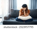 Breakup, depression or sad woman waiting for call for relationship stress or anxiety on couch. Impatient, lonely and upset girl disappointed by toxic cyberbullying message on phone or mobile in home