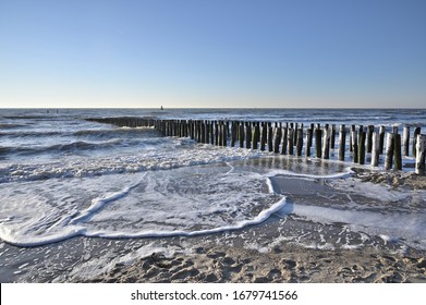 Breakwaters on a winter beach in Vlissingen Holland
