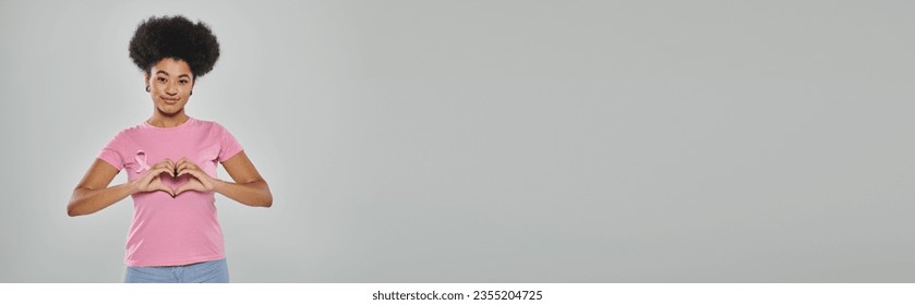 breast cancer awareness, african american woman with pink ribbon on grey backdrop, heart, banner - Powered by Shutterstock