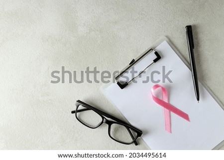 Breast cancer awareness concept on white textured table