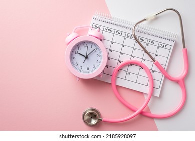 Breast cancer awareness concept. Top view photo of pink alarm clock calendar and stethoscope on bicolor pastel pink and white background - Shutterstock ID 2185928097