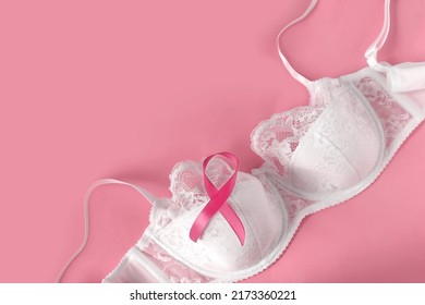 Breast cancer awareness and healthcare and medicine concept. Pink ribbon on white lace bra. Copy space.