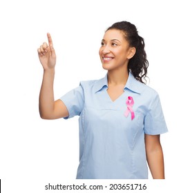 breast cancer awareness, healthcare and technology concept - african american doctor or nurse pointing to something or pressing imaginary button - Shutterstock ID 203651716