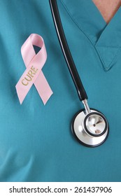 Breast Cancer Awareness Ribbon Pinned To Lapel Of Nurse