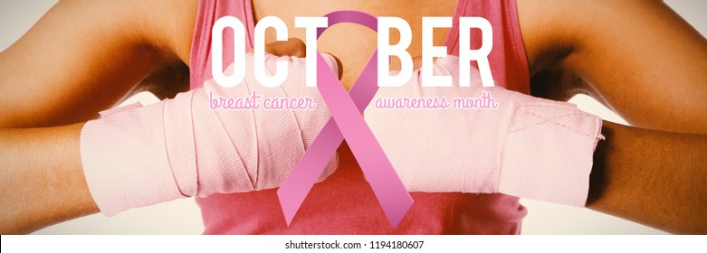 Breast cancer awareness ribbon with text against mid section of woman for breast cancer awareness - Powered by Shutterstock