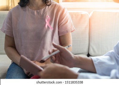 Breast Cancer Awareness With Woman Patient Wearing Pink Ribbon Consulting With Doctor Who Diagnostic Examining On Obstetric - Gynaecological Female Illness In Medical Clinic Or Hospital