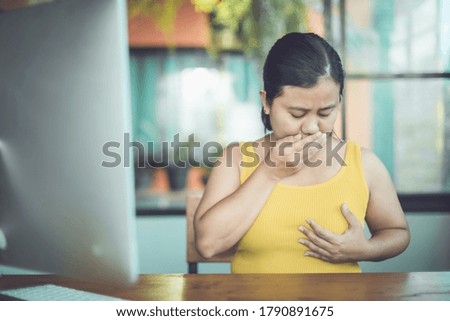 Breast Cancer concept : Asian woman looking her breast and feeling sad after checking breast by herself that risky to cancer