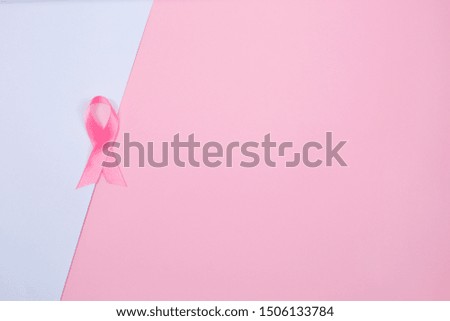 Breast Cancer concept : Pink ribbon symbol of breast cancer on light background. Copy space