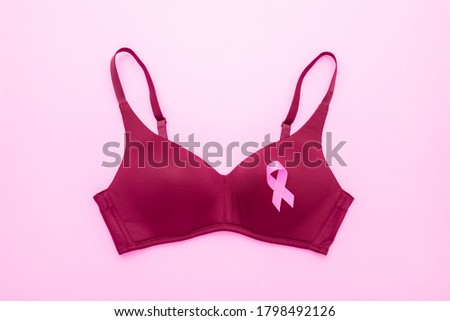 Breast Cancer concept : Pink ribbon and women bra symbol of breast cancer campaign on color background
