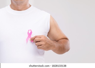 Breast cancer in men concept : Portrait Asian man and pink ribbon the symbol of breast cancer campaign. Studio shot isolated on grey background
