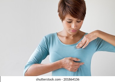 Breast cancer self check; healthy girl, woman healthy lifestyle medical awareness; woman breast cancer self awareness; breast cancer checking, cancer prevention concept;  asian young adult woman model - Shutterstock ID 201864136