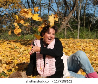 Breast Cancer Survivor Throwing Leaves In Air, Laughing