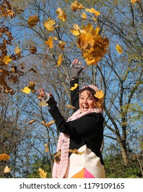 Breast Cancer Survivor Throwing Leaves In Air Laughing