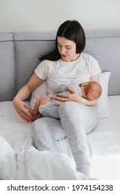Breast feeding mama at home. Baby breastfeed on mothers hands, Cuddle a baby and talking to son