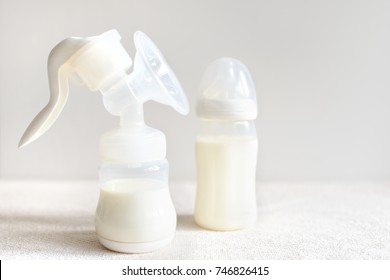 Breast pump and bottle with milk for baby