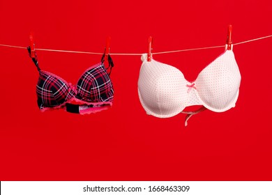 Breast size. Big and small breasts. Brassiere. Women's lingerie hanging at rope . Bra and bustiers. Small little or big breast size