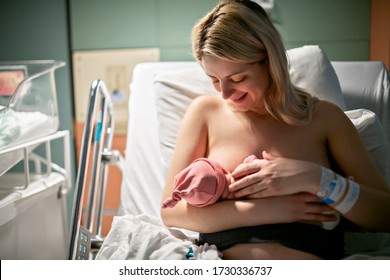 A Breastfeed Mother With Her Newborn Baby At The Hospital A Day After A Natural Birth Labor