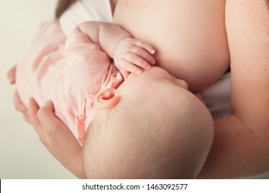 Breastfeeding Baby Held By Mother 