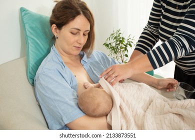 Breastfeeding consultant supports young mother to overcome problems - Shutterstock ID 2133873551
