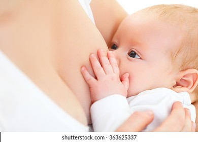 breastfeeding. mother holding newborn baby in an embrace and breastfeed