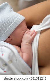 Breastfeeding. Newborn baby drinking breast milk of his mother. 
