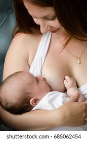 Breastfeeding. Young Mother Nursing Baby. Woman Breast Feeding Newborn.