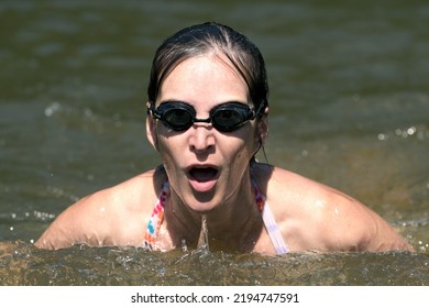 Breaststroke Swimming. Female Swimmer With Black Glasses Taking Breath Above Water. Fast Shutter. 