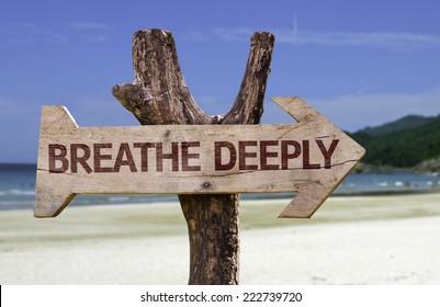 Breathe Deeply Wooden Sign With A Beach On Background