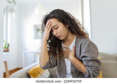 Breathing, respiratory problem, asthma attack, pressure, chest pain, sun stroke, dizziness concept. portrait of woman received heatstroke in hot summer weather, touching her forehead