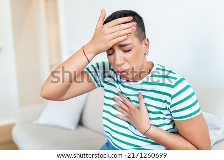 Breathing, respiratory problem, asthma attack, pressure, chest pain, sun stroke, dizziness concept. portrait of woman received heatstroke in hot summer weather, touching her forehead