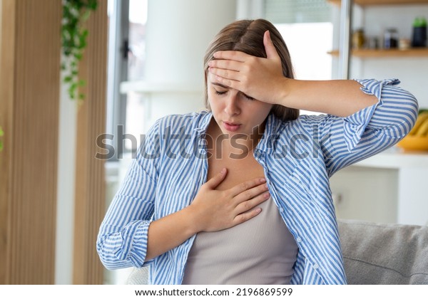 Breathing,\
respiratory problem, asthma attack, pressure, chest pain, sun\
stroke, dizziness concept. portrait of woman received heatstroke in\
hot summer weather, touching her\
forehead