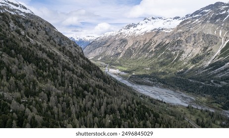 Breathtaking Aerial View of the Alpine Valley Surrounded by Snow-Capped Mountains During Daytime - Powered by Shutterstock