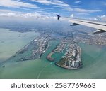 A breathtaking aerial view of a coastal cityscape captured from an airplane window