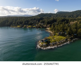 A breathtaking aerial view of the Gulf Islands, showcasing lush forests, rocky coastlines, and clear waters under a bright blue sky. Perfect depiction of natural and serene landscapes in BC - Powered by Shutterstock