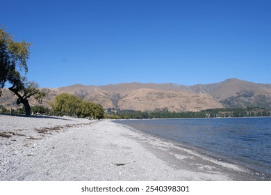 Breathtaking Aerial View of Lake Wānaka Surrounded by Majestic Mountains and Lush Greenery in South Island, New Zealand - Powered by Shutterstock