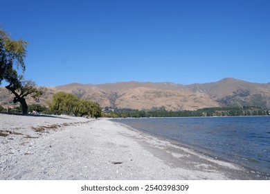 Breathtaking Aerial View of Lake Wānaka Surrounded by Majestic Mountains and Lush Greenery in South Island, New Zealand - Powered by Shutterstock