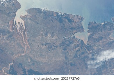 A breathtaking aerial view of a majestic mountain range, showcasing snowcapped peaks, lush valleys, and dramatic slopes. The clouds dance across the sky,. Elements of this image furnished by NASA - Powered by Shutterstock