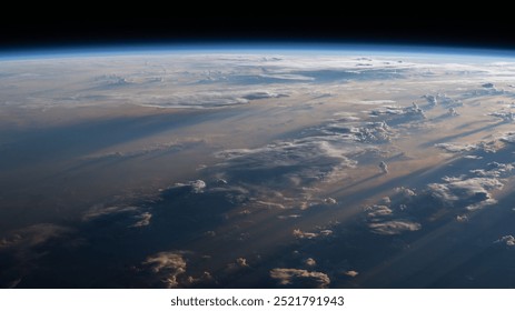 A breathtaking aerial view of a mountain range, showcasing snowcapped peaks piercing the blue sky.  Fluffy cumulus clouds drift across the horizon, creat. Elements of this image furnished by NASA
